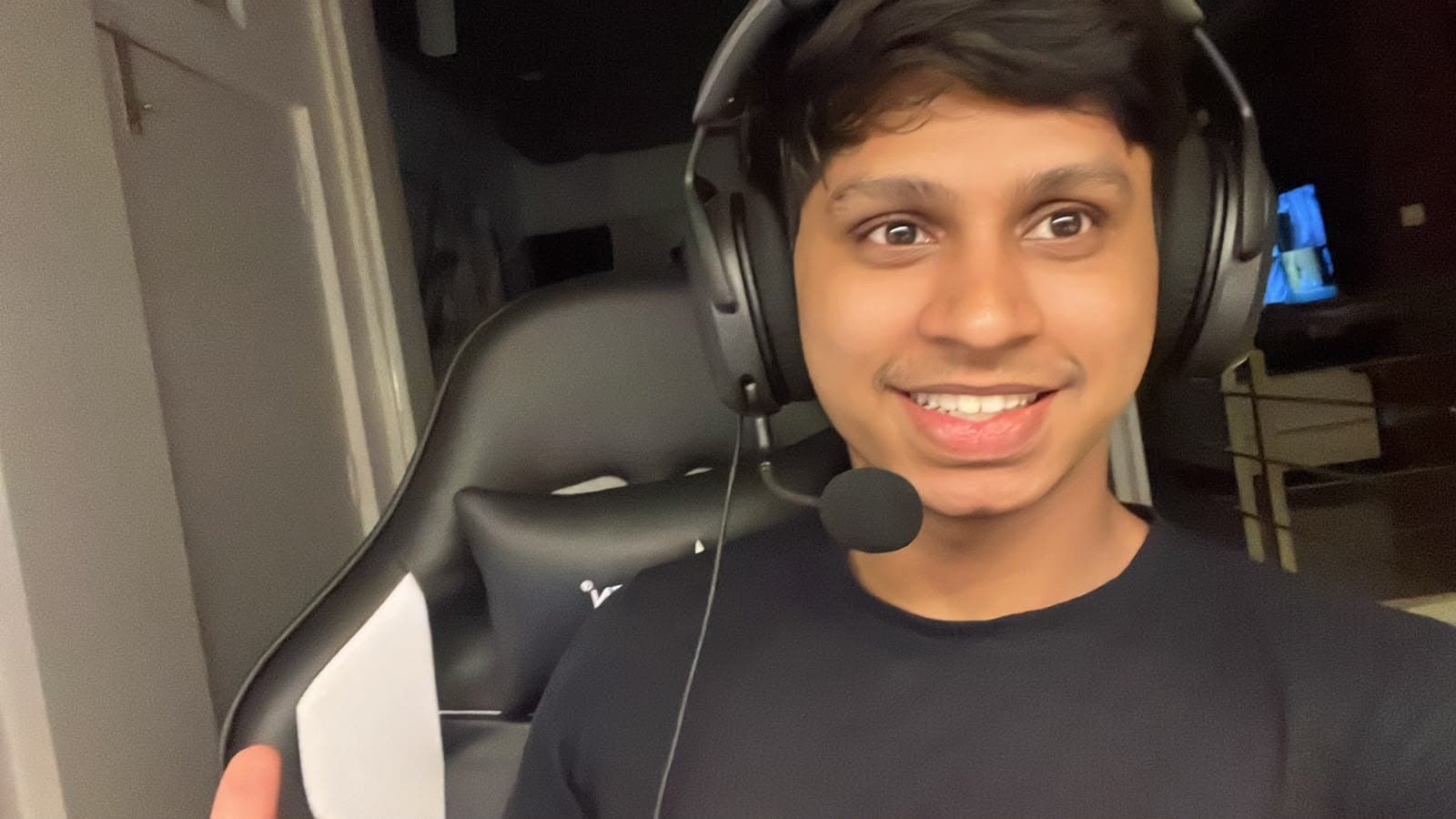 Prathith wearing a headset, smiling at the camera